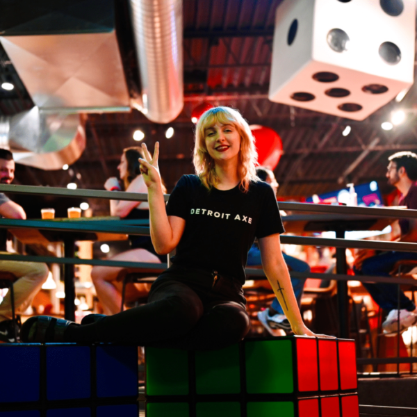 Girl Sitting On Life-size Rubik's Cube